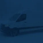 A Windy Expedite truck operating safely on a treated highway during a February winter storm.