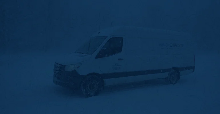 A Windy Expedite truck operating safely on a treated highway during a February winter storm.