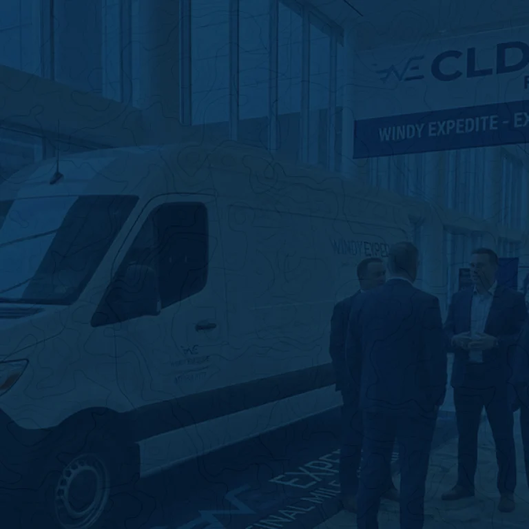 A professional presentation stage and networking area at a corporate logistics and supply chain conference.